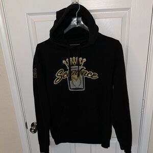 The Concert Fleece Men’s District Black Hoodie with Gold Graphic Size Medium.